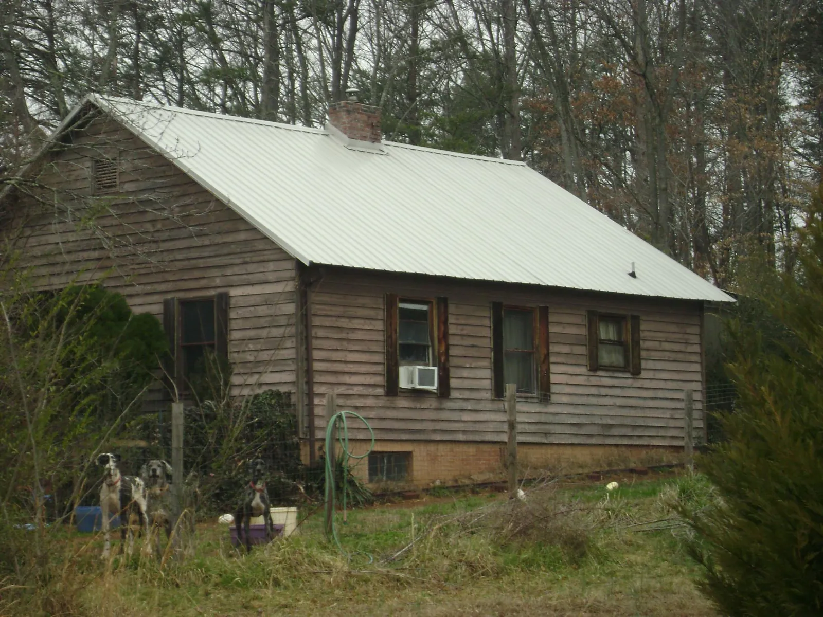 White metal roof on an old wood sided farmhouse, from a Metal Roof Installation job in Quebeck